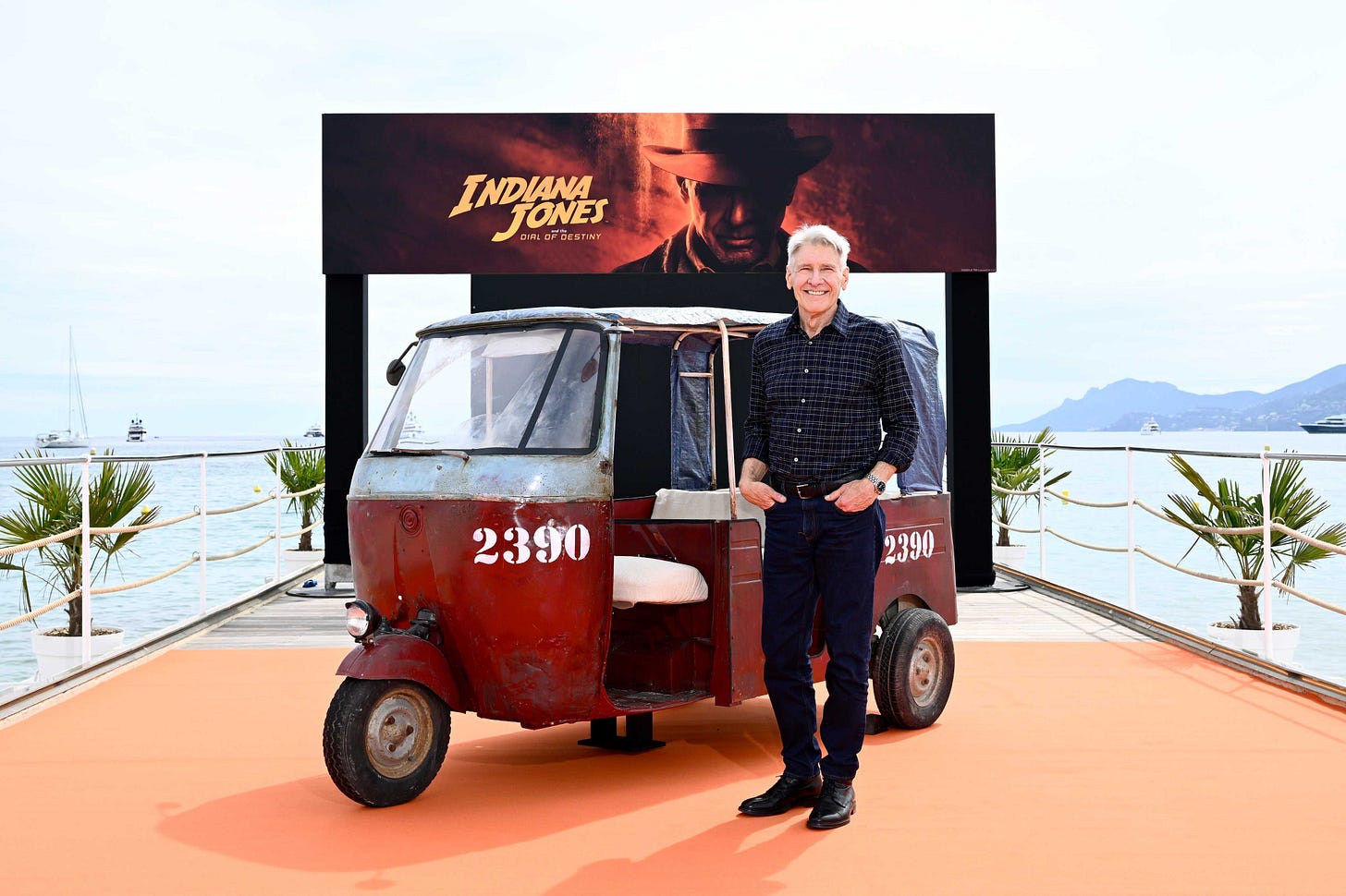 Harrison Ford in front of an Indy poster