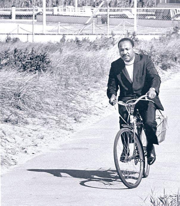 Photo by Bernice A. King on January 20, 2025. May be a black-and-white image of 1 person, bicycle, scooter and text.