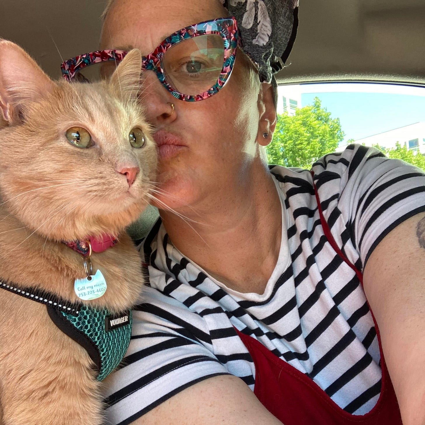 A selfie of Melissa and her cat Gus in the car.
