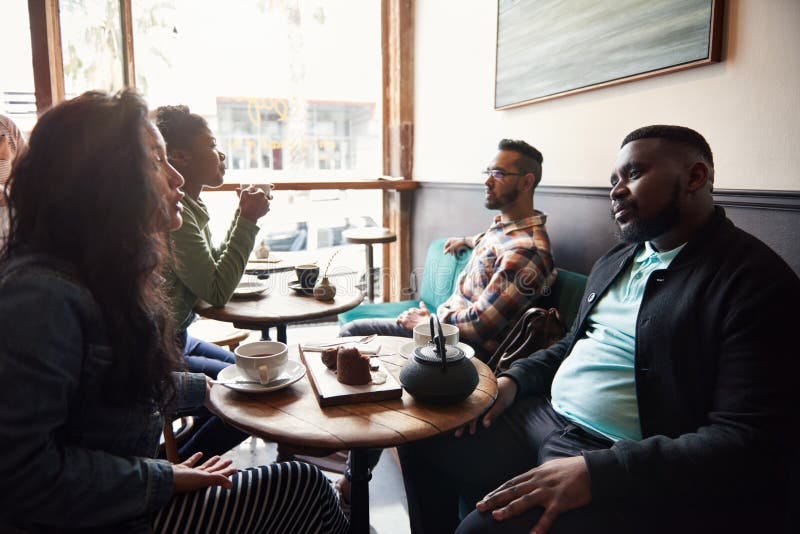 Diverse Friends Talking Together Over Coffee in a Cafe Stock Photo ...