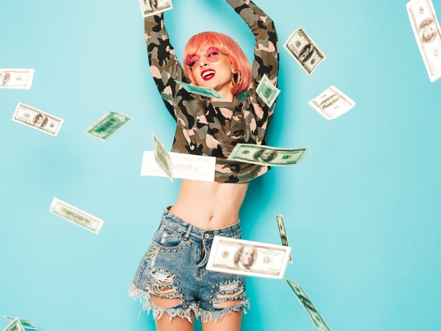 Young woman dancing in money rain.