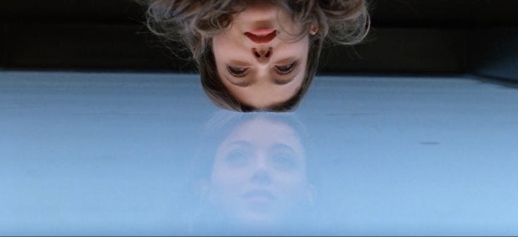 This may contain: a woman with her head upside down in the air This may contain: a woman with her head upside down in the air