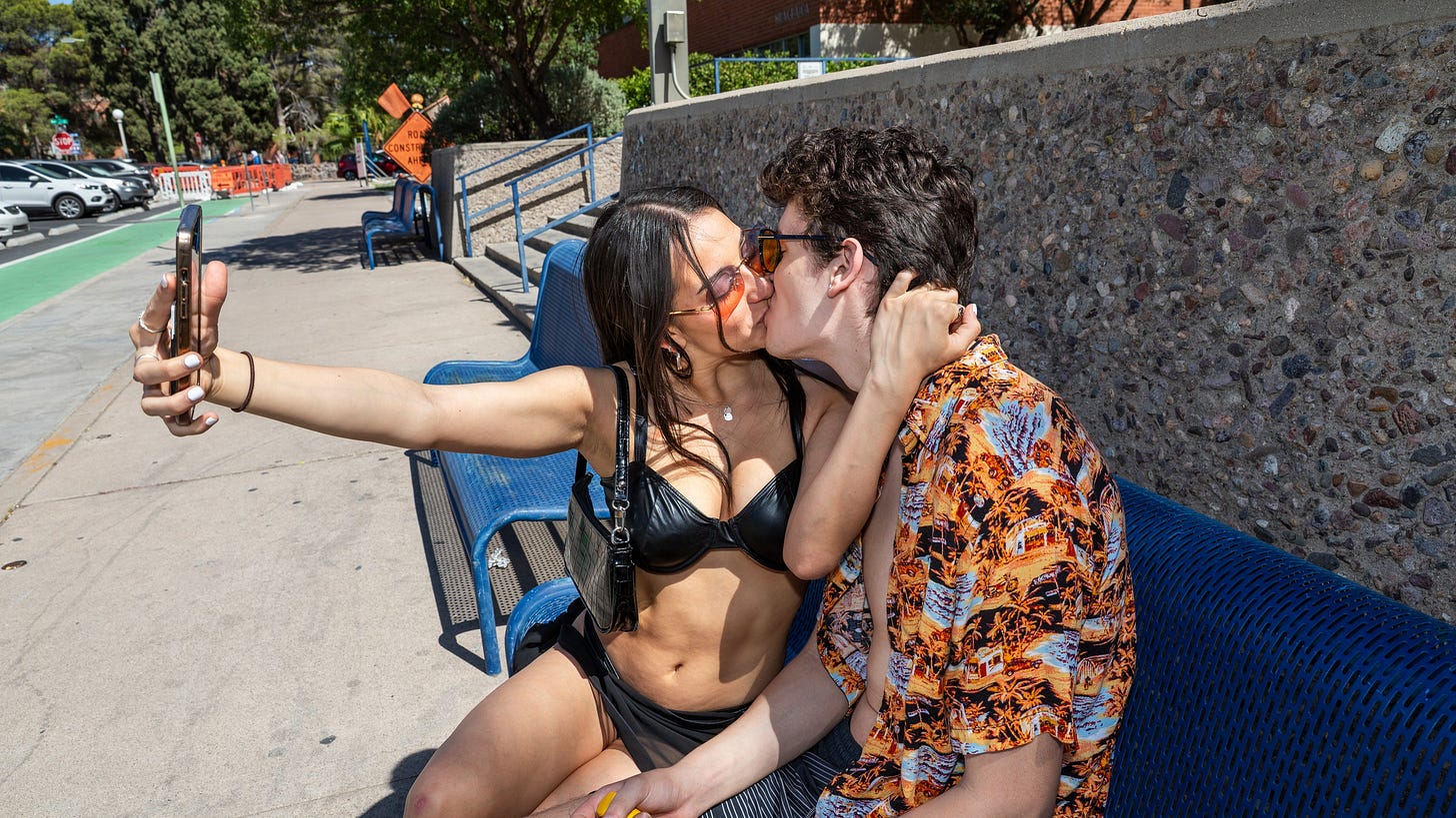 Two people kissing. One of them takes a selfie. Two people kissing. One of them takes a selfie.