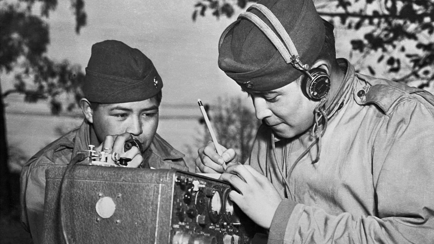 A two-man team of Navajo code talkers attached to a Marine regiment in the Pacific relay orders over the field radio using their native language. The Navajo language was a particularly effective code during World War II, as it is not a written language and few people understand it.