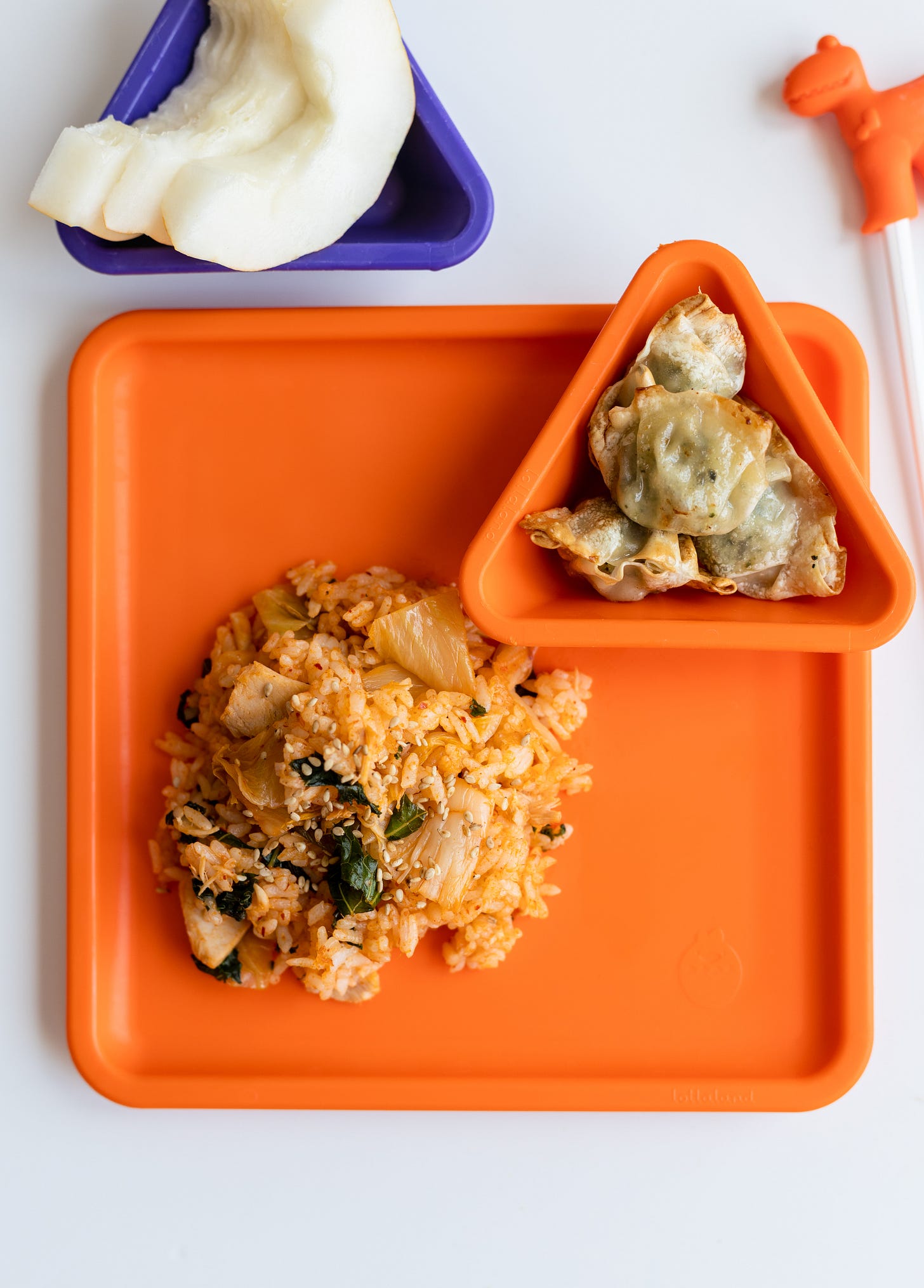 Kimchi kale fried rice and dumplings on orange square plate Kimchi kale fried rice and dumplings on orange square plate