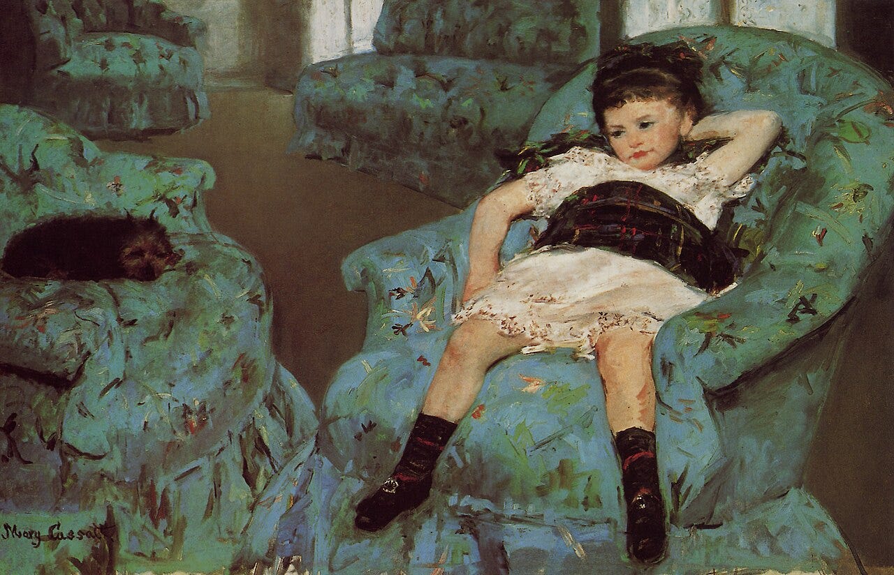 A small girl sprawls sideways in a large blue armchair, bored and restless, a dog nearby A small girl sprawls sideways in a large blue armchair, bored and restless, a dog nearby