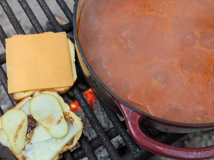 Roasted tomato soup with grilled cheese (and bacon!) cooking over our camp fire last month