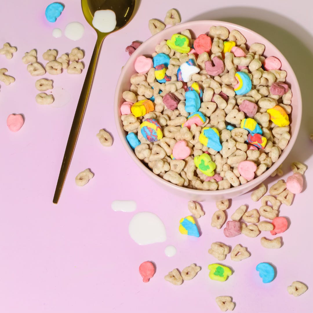 Cereal in a pink bowl and spilled onto a pink counter