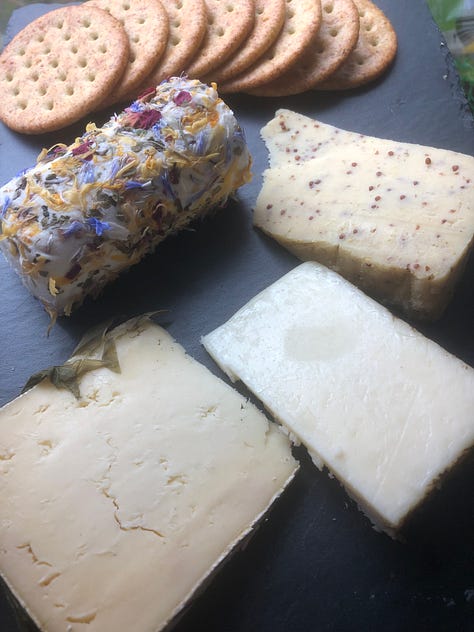 A selection of reasonable food photos, one risotto with tomatoes on a white plate, onei of roasted asparagus and oozing cheese on a white plate, cheese selection on a slate and
