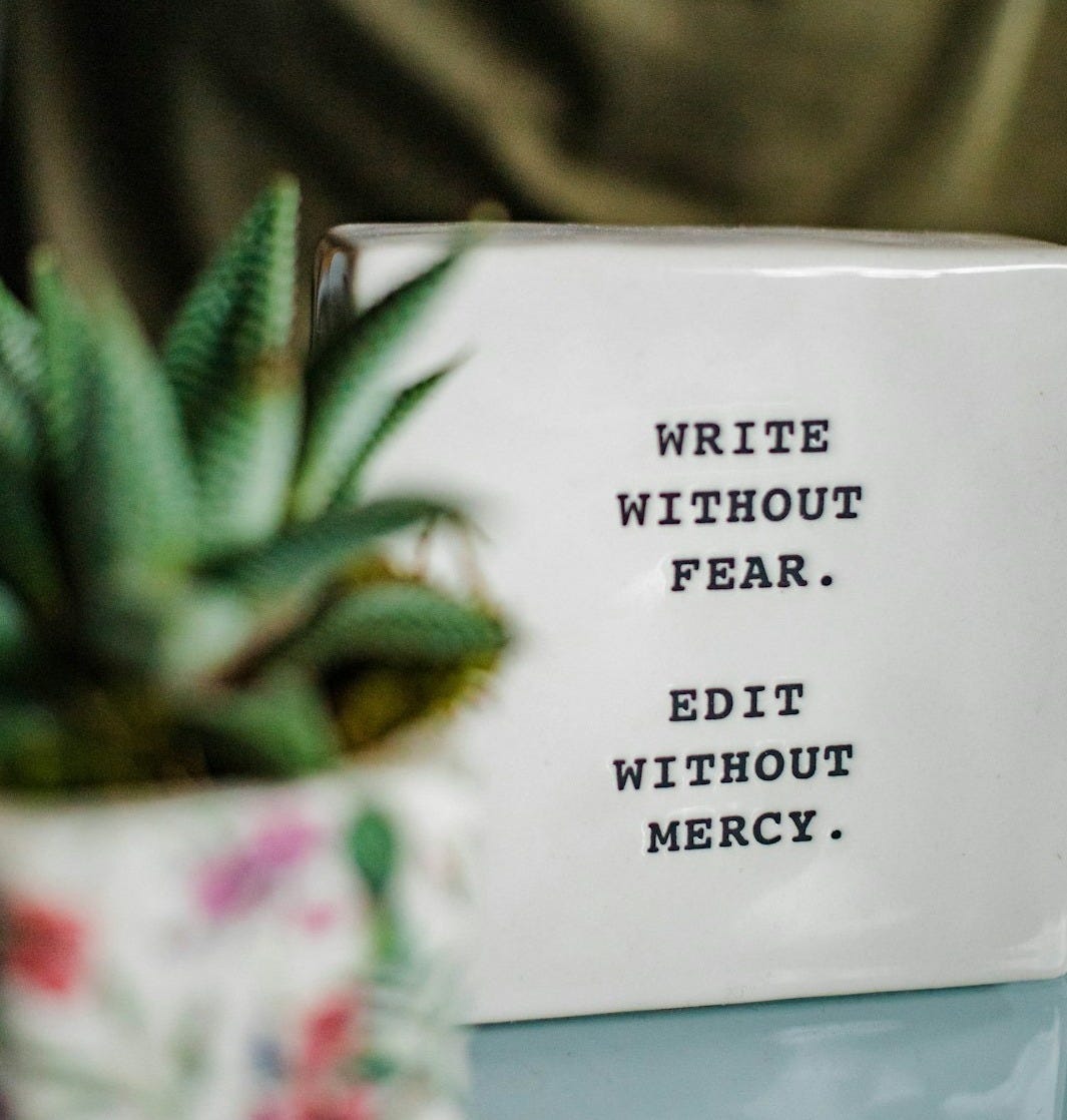 a white box with writing on it next to a plant a white box with writing on it next to a plant