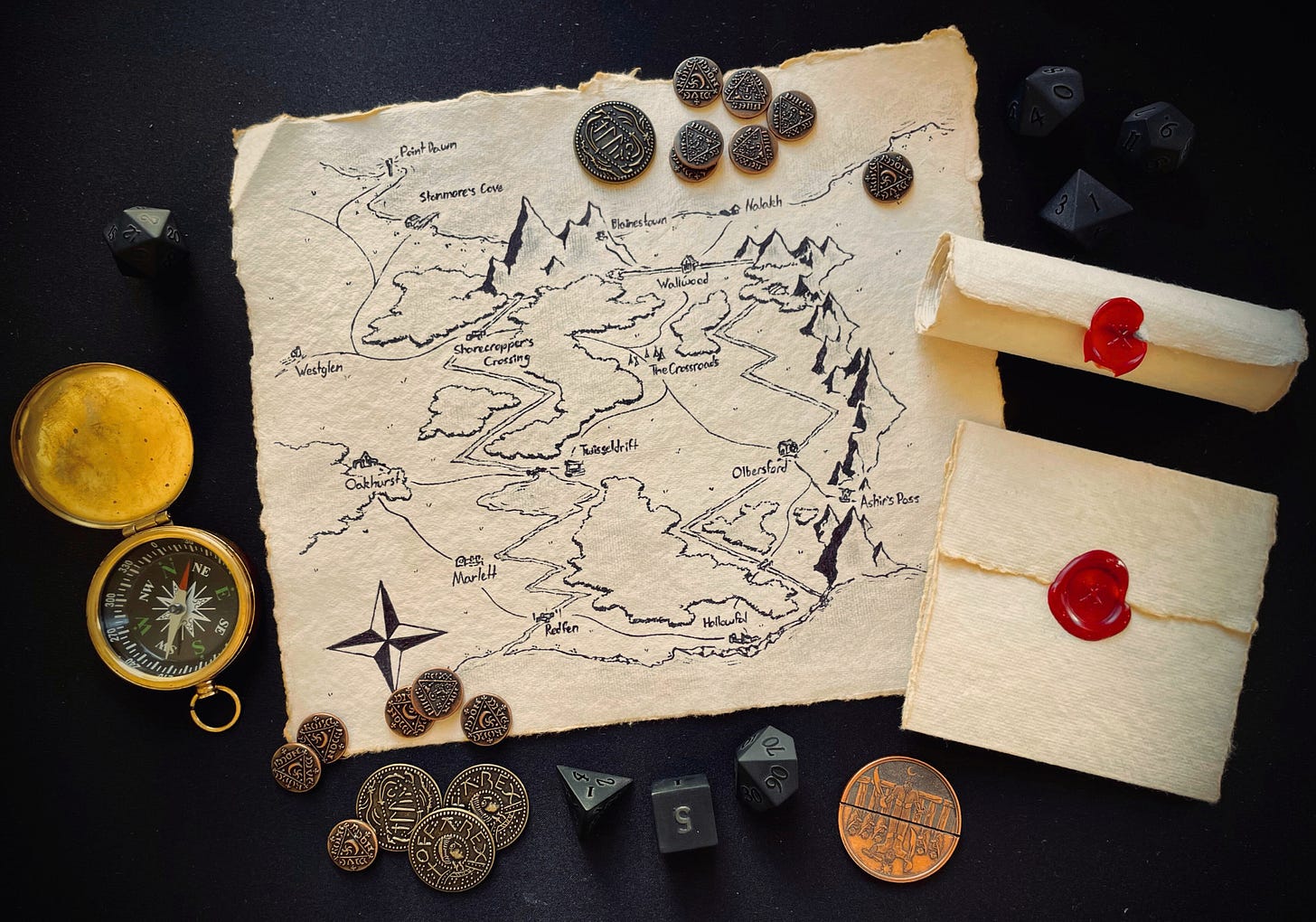 A hand-drawn map on heavy parchment sits beside wax-sealed documents. Fantasy coins and dice lay scattered overtop.
