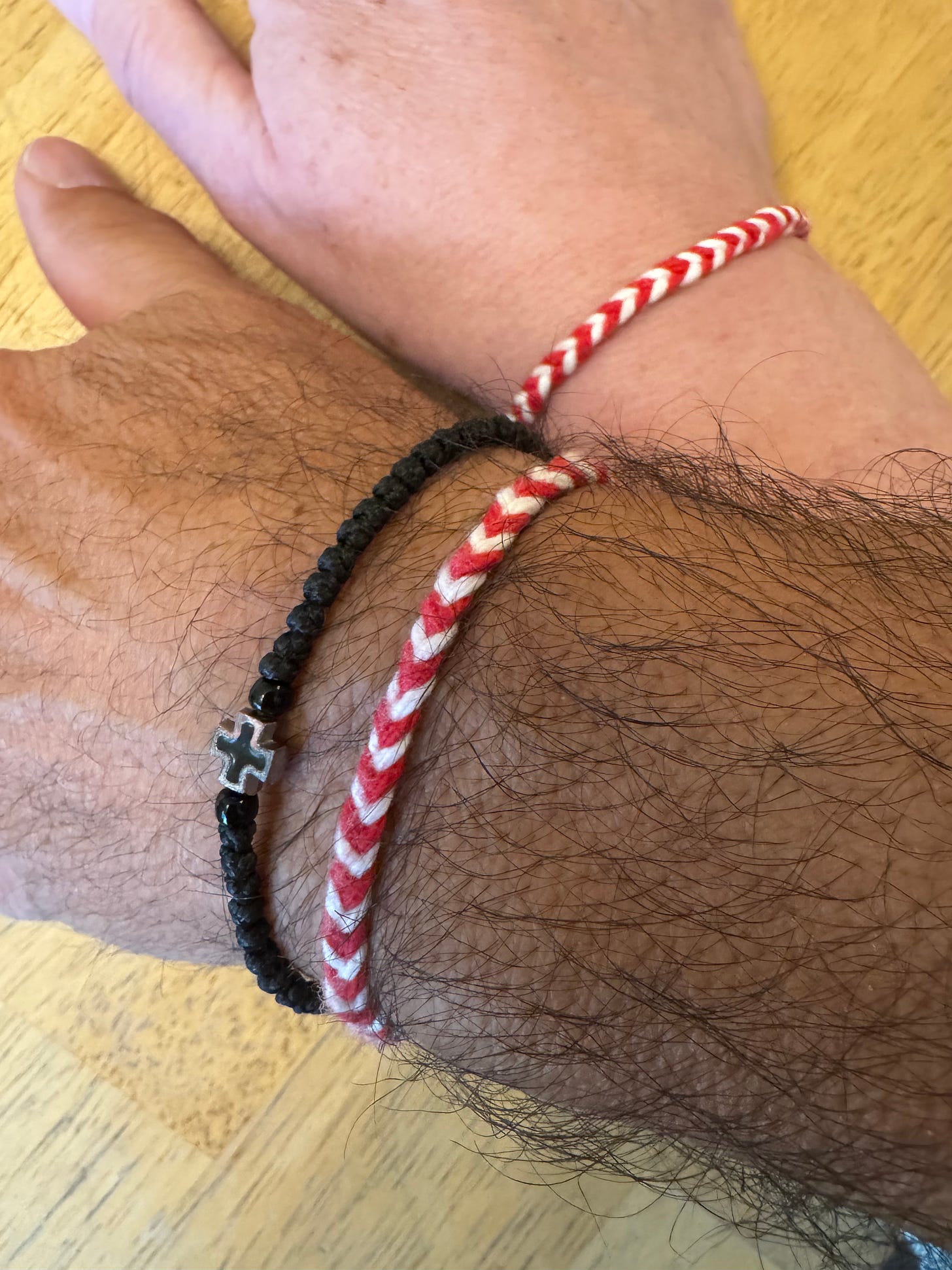 Red and white wrist bands on two wrists. Red and white wrist bands on two wrists.