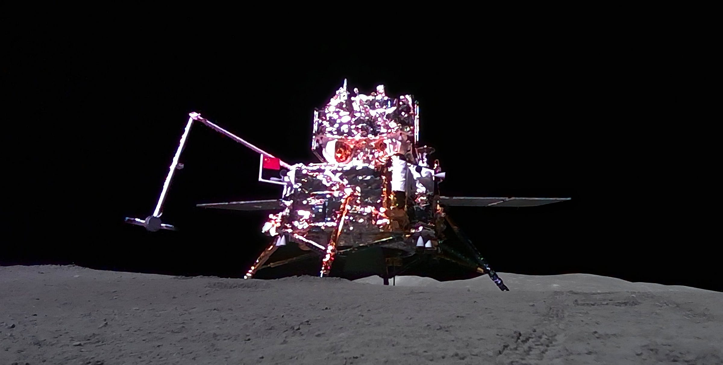 The Chang’e 6 lunar lander on the Moon’s surface during sample collection operations, as seen by a small rover.