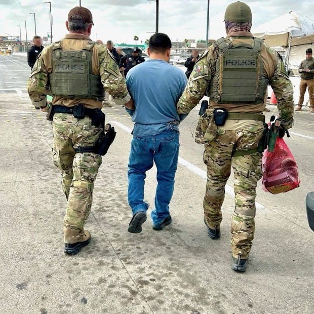 US Immigrations & Customs Enforcement Agents escort suspect in 43 murders toward the international boundary with Mexico from Texas. US Immigrations & Customs Enforcement Agents escort suspect in 43 murders toward the international boundary with Mexico from Texas.