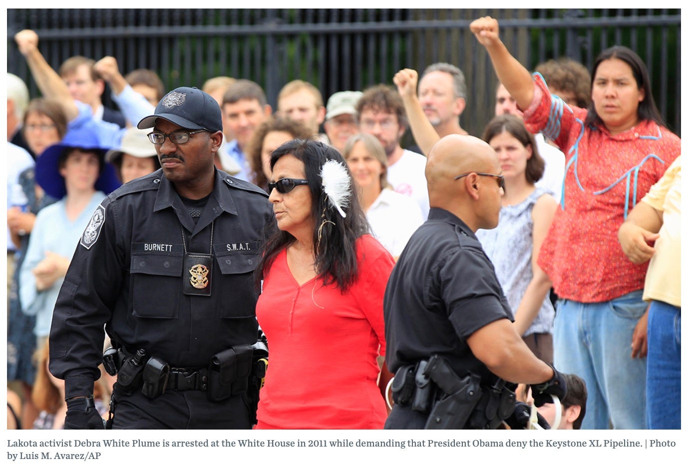 Lakota activist Debra White Plume is arrested at the White House in 2011 while demanding that President Obama deny the Keystone XL Pipeline. | Photo by Luis M. Avarez/AP