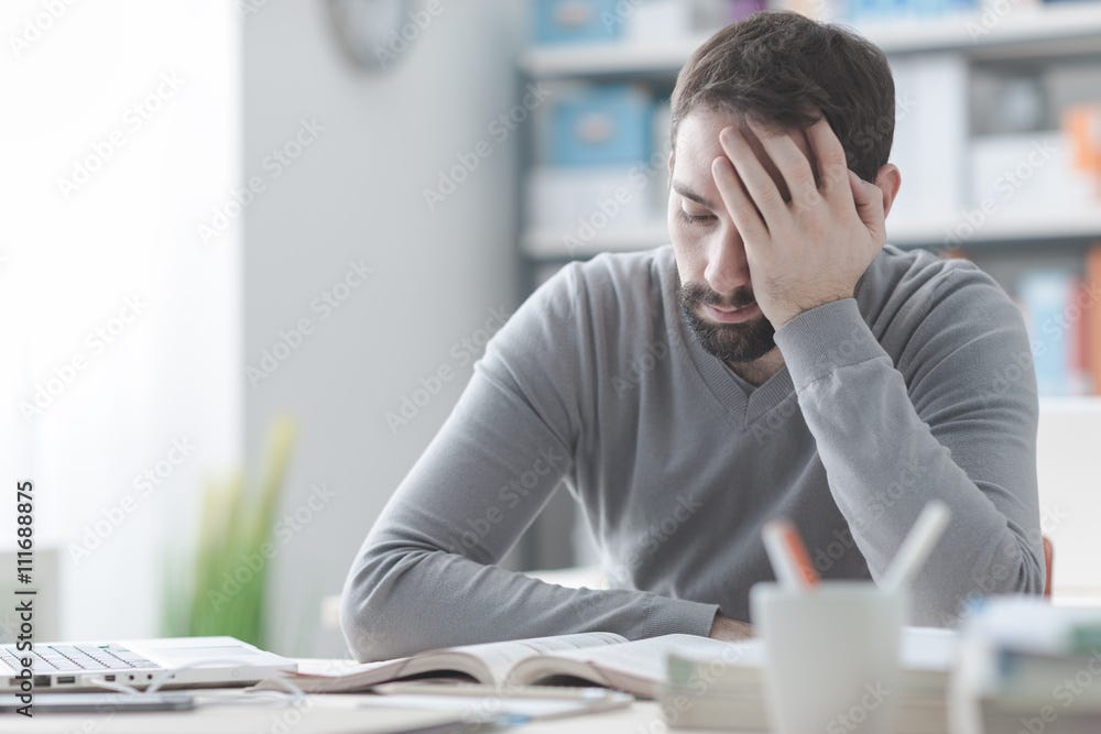 Exhausted man with headache Stock Photo | Adobe Stock