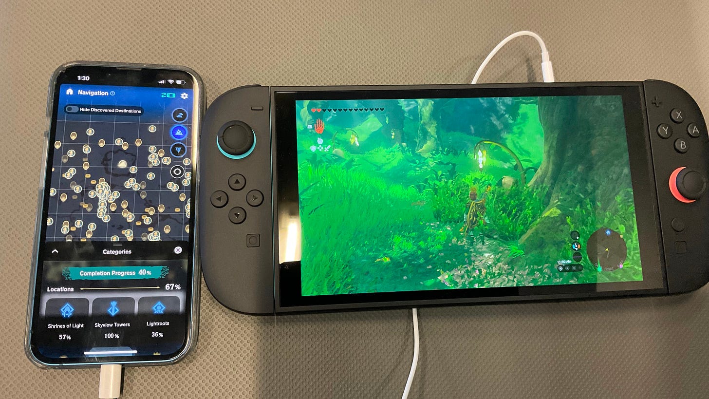 Photo of a Switch 2 running a Zelda game and a phone showing the game's map, covered with icons Photo of a Switch 2 running a Zelda game and a phone showing the game's map, covered with icons