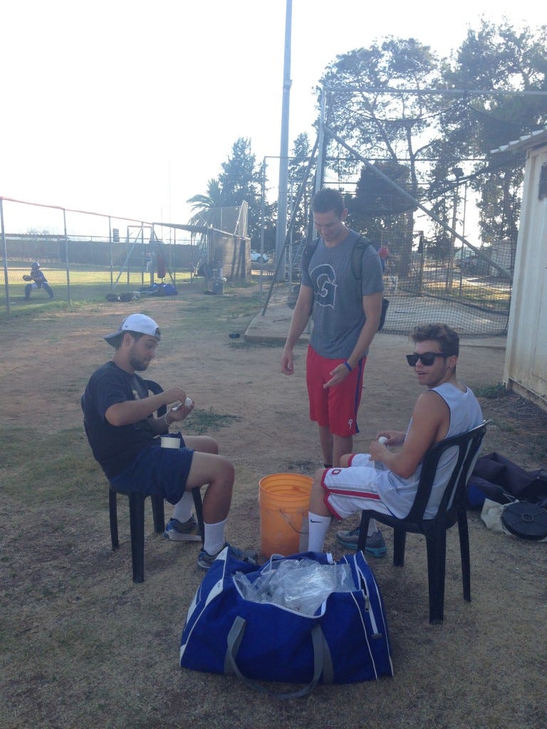 D-Ho, Vitamin AJ, and J-Max tape up whiffle balls before a National Team practice.