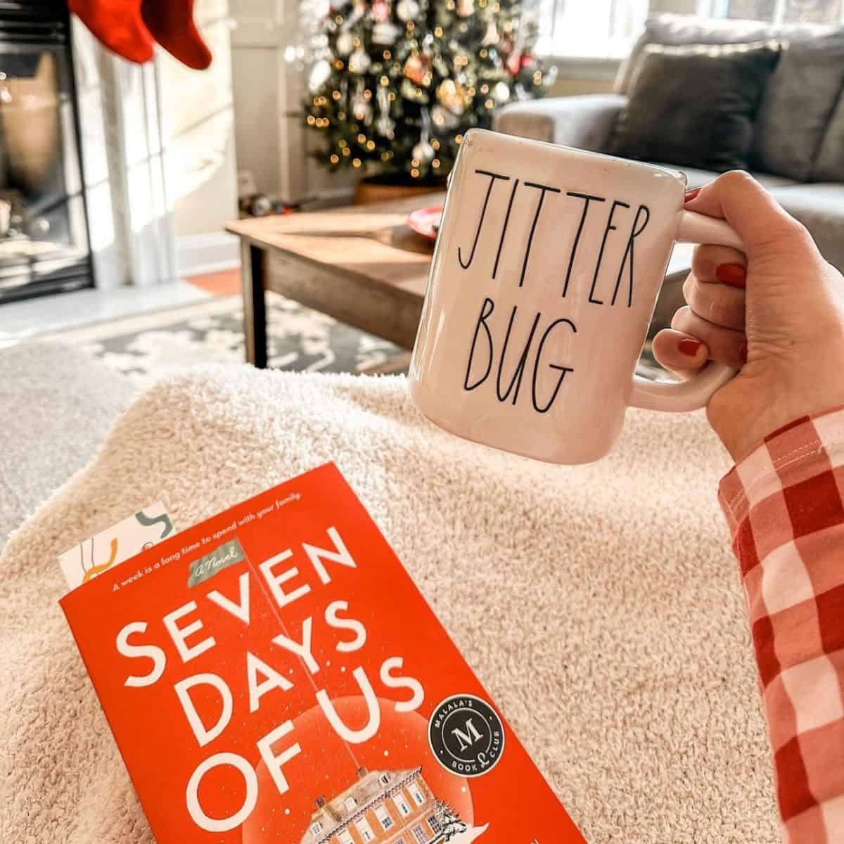 reading a christmas book and drinking hot chocolate by the tree reading a christmas book and drinking hot chocolate by the tree