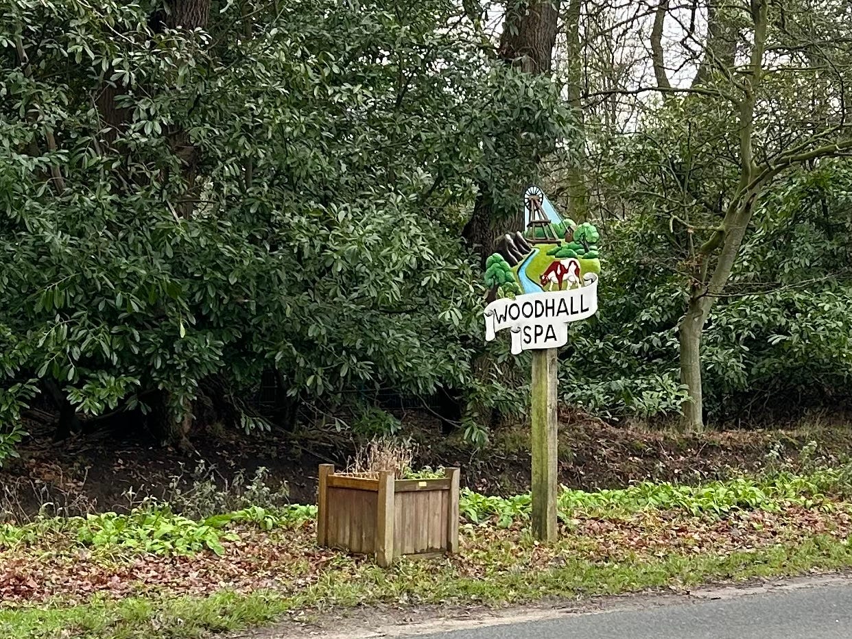 A colourful road sign welcoming visitors as they drive in to Woodhall Spa, Lincolnshire