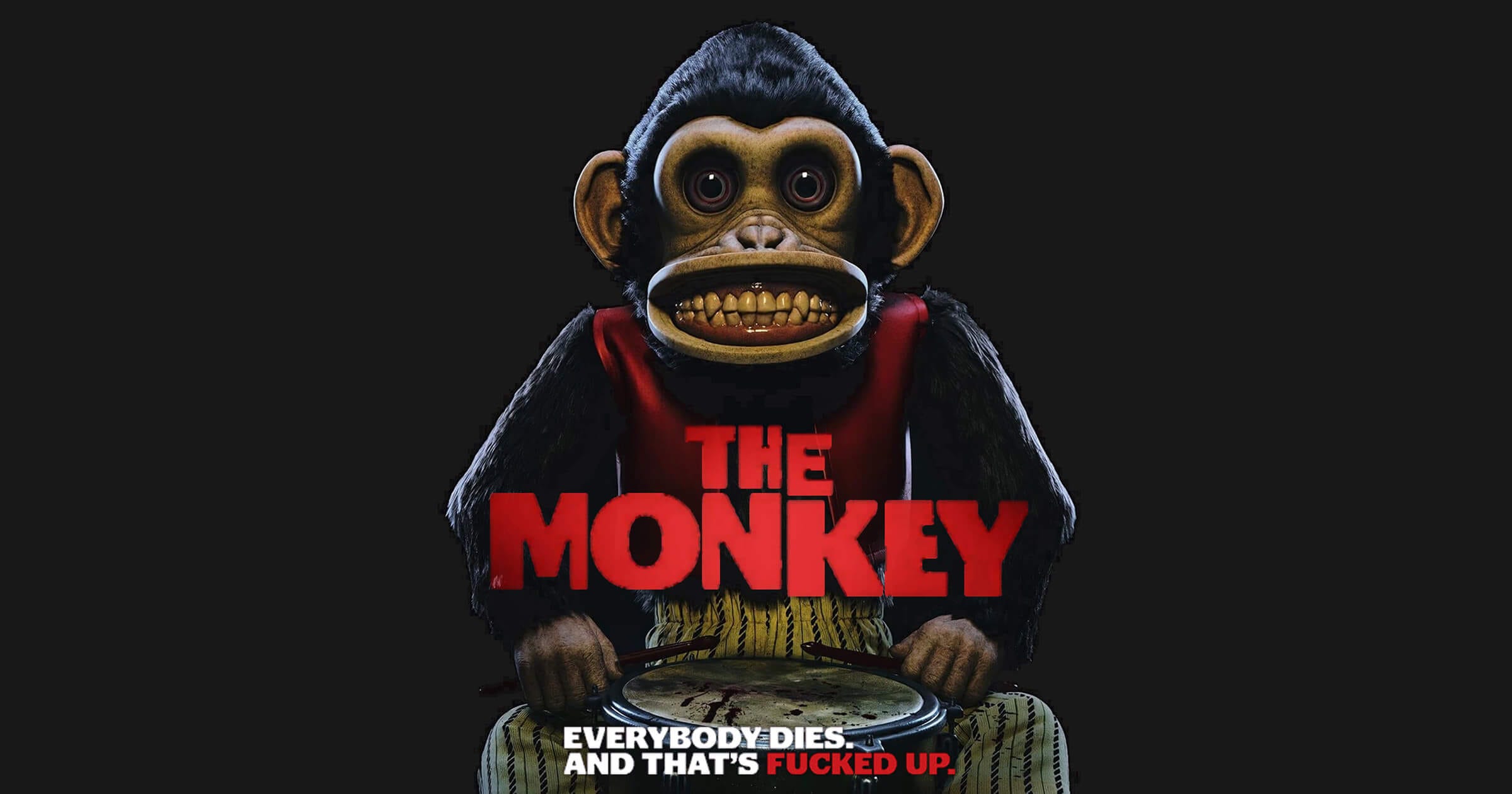 Poster art for The Monkey (2025, featuring a drum-beating monkey toy bearing human teeth in a wide grin, staring blankly beneath the film's tagline: “Everybody dies. And that’s fucked up.”