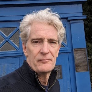 Photo of author James McCrone in front of a Dr. Who-style police box, in Edinburgh Photo of author James McCrone in front of a Dr. Who-style police box, in Edinburgh
