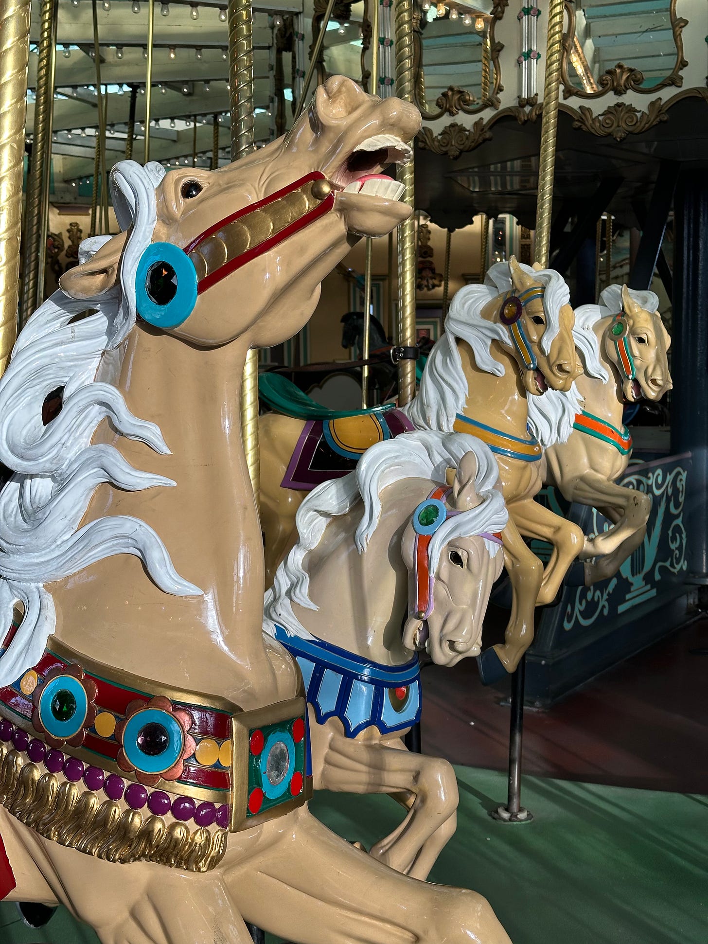 three tan carousel horses