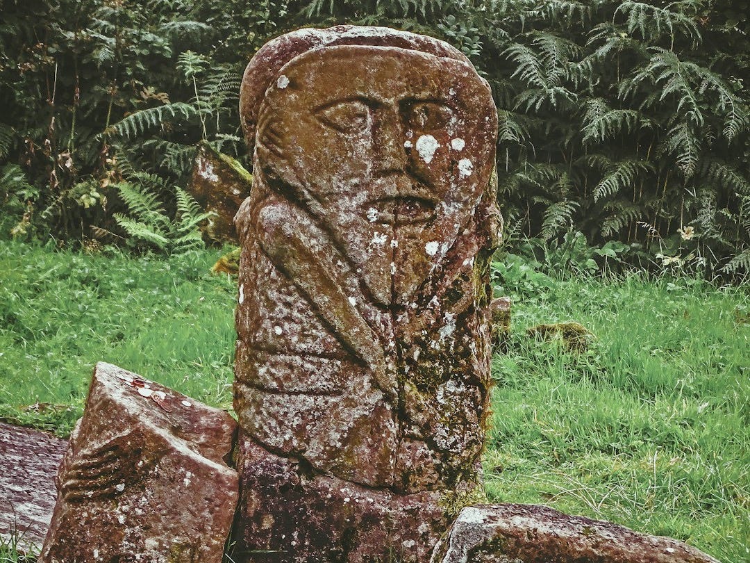 brown historic statue on green field