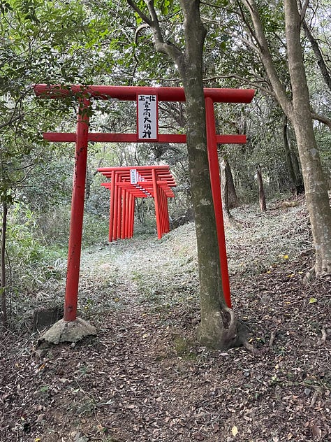 Distant view of Akashi Kaikyo Bridge and shrine toriis
