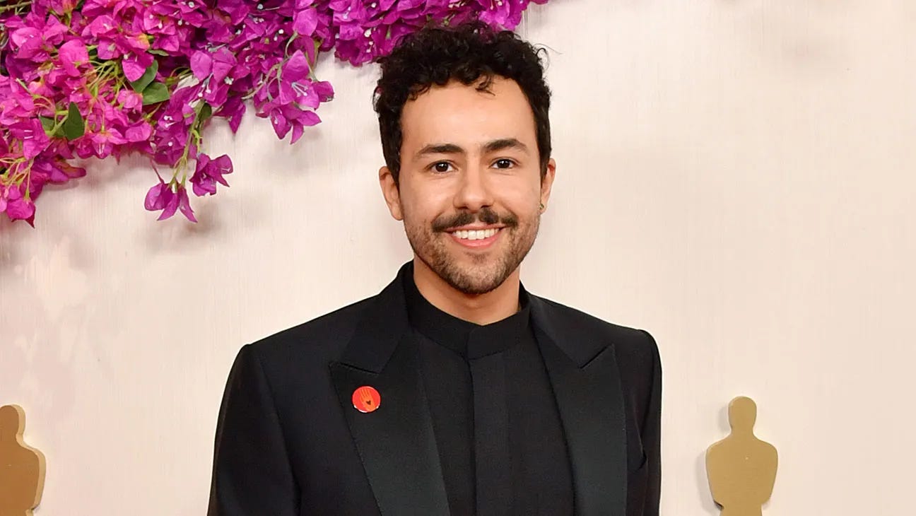 Ramy Youssef looking extremely attractive at the Emmy Awards with a mustache and a "ceasefire now" pin.