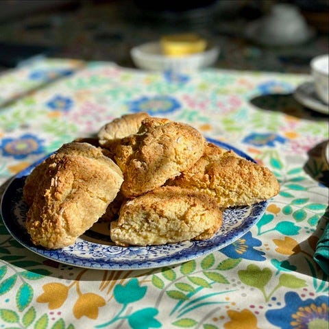 Plate of scones on a decorative table cloth. Plate of scones on a decorative table cloth.