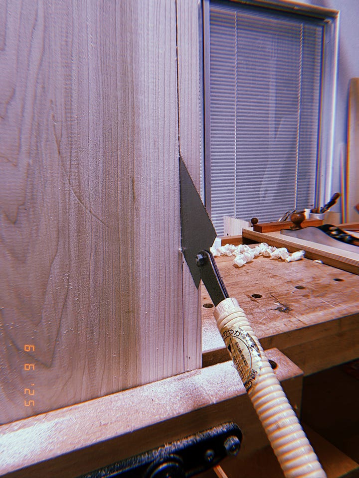 one photo of Japanese Ryoba sawing the width of a piece of poplar, one of a bunch of pieces of poplar balanced on small saw horses. 