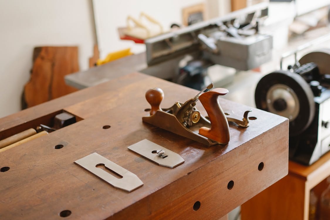 Dissassembled bench plane laid out on a workbench. Dissassembled bench plane laid out on a workbench.