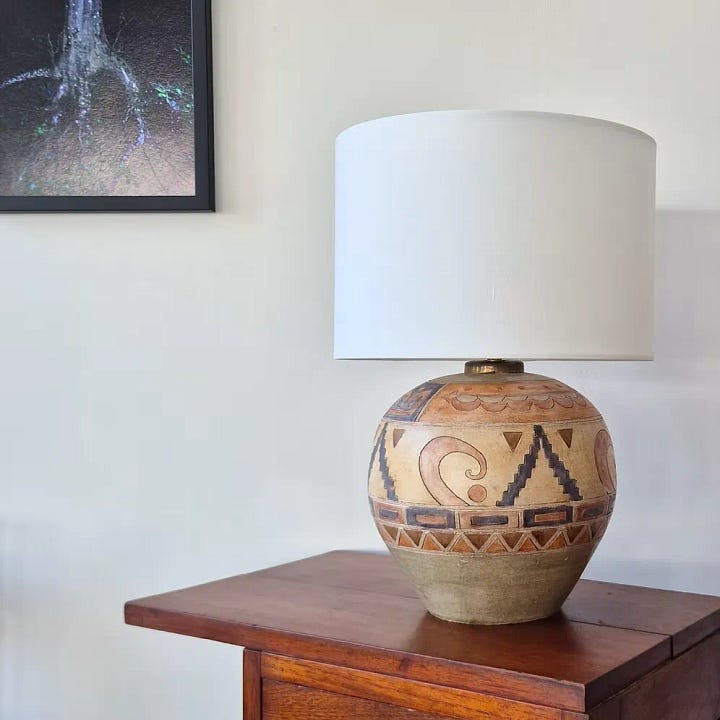 a ceramic wall light, a brown lamp with cream fabric shade, a marble lampshade, a vintage terracotta lamp 