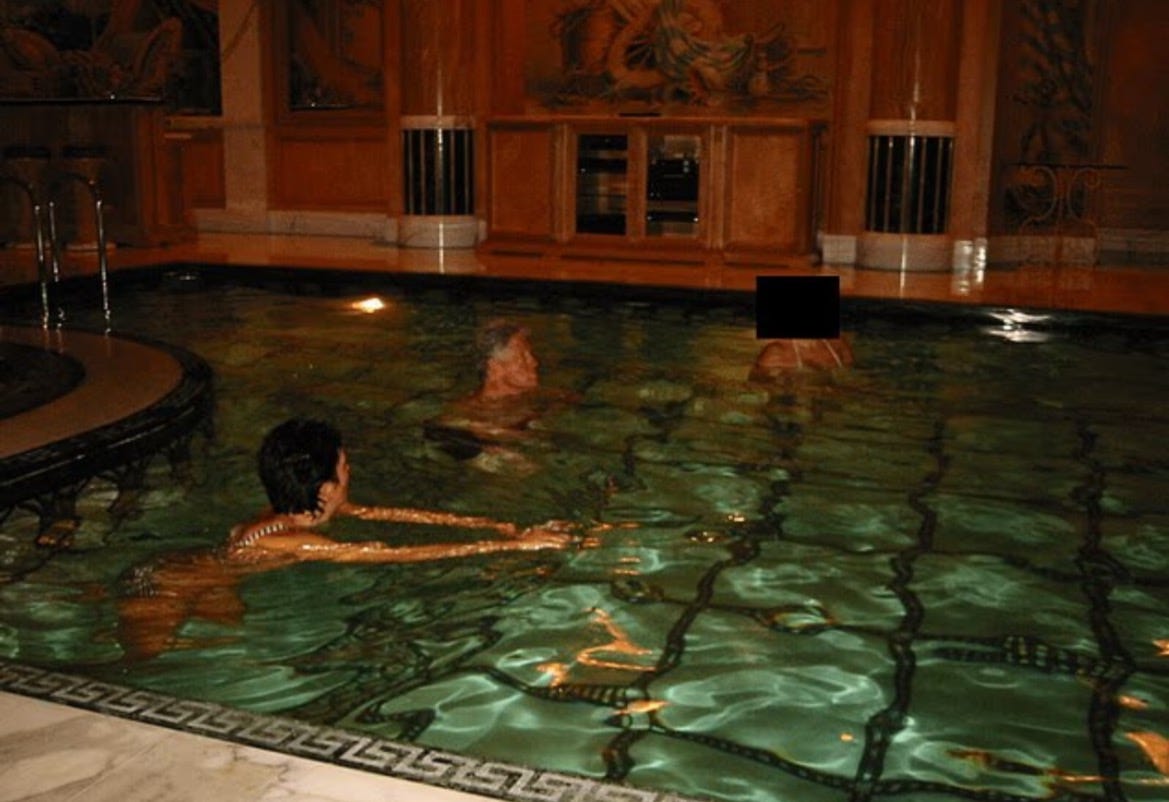 Indoor swimming pool scene with two people enjoying the water, surrounded by elegant decor and soft lighting.