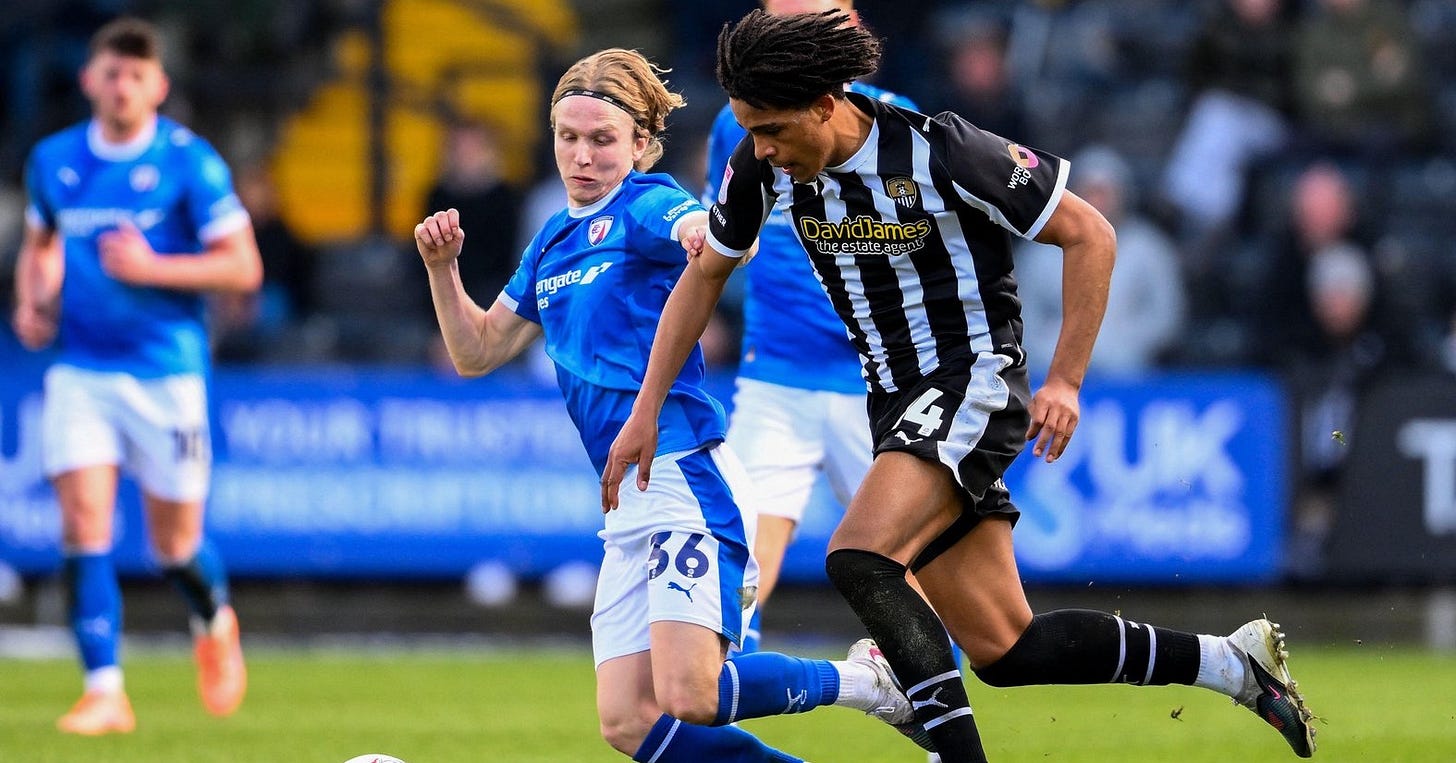 A Chesterfield player wearing the number 36 shirt challenges a Notts County’s loanee Tom Iorpenda during a League Two match.​​​​​​​​​​​​​​​​