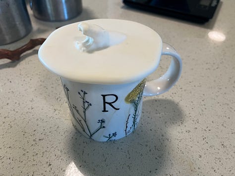 six photos: 1. a passionfruit flower close up 2. four sprays of bright pink orchids 3. A deep red hibiscus flower 4.  a blue bowl with white yogurt, above it is a long, deep wooden spoon with a beige powder 5. a coffee cup with the letter “R” on it with a white circular top. In the centre of the top is a hippo head 6. a view from an interior window looking out an open window which reveals rolling countryside beyond.