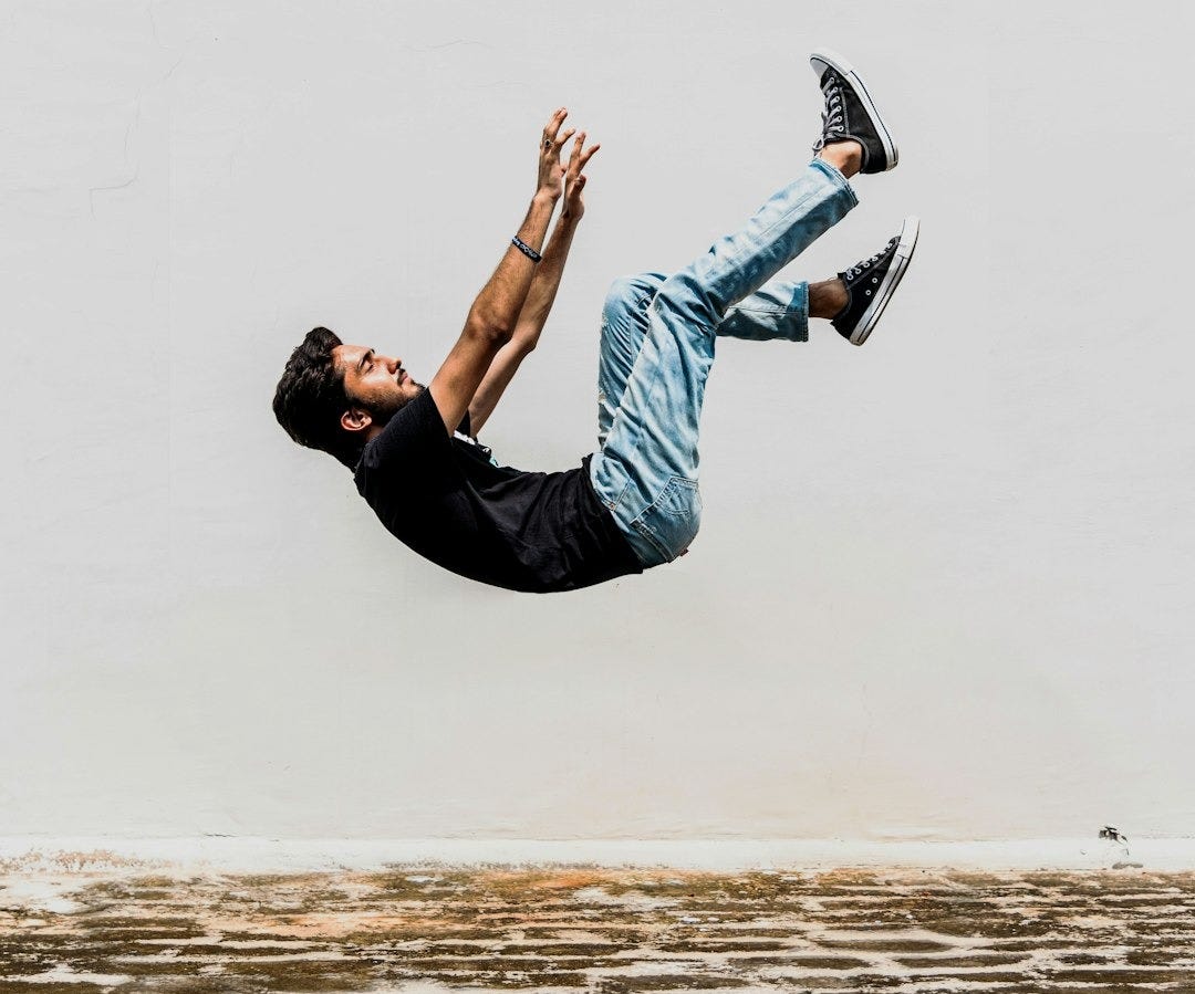 man in black T-shirt falling