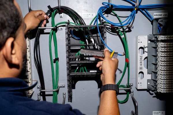 A man working with electrical wires.