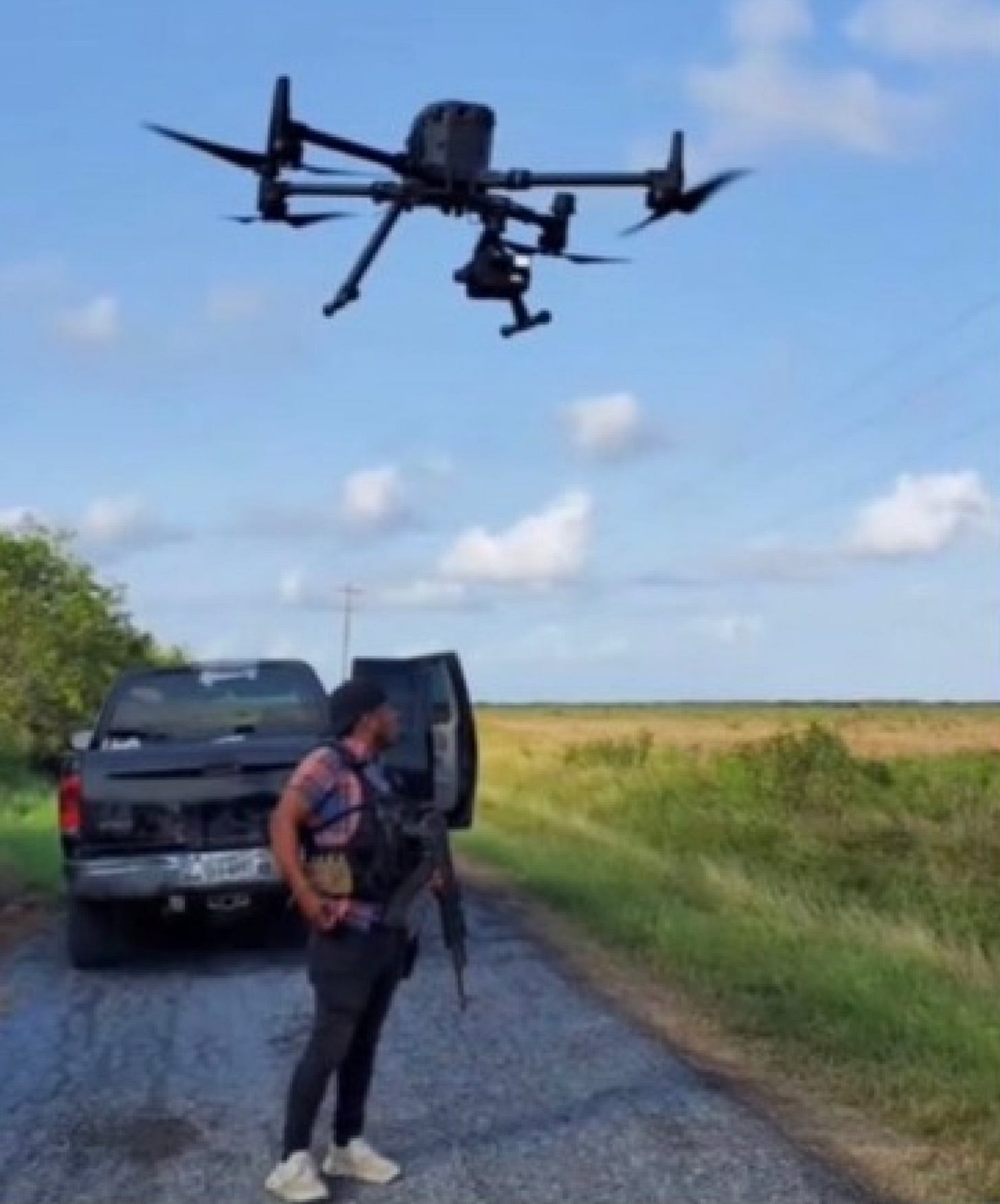 Image from a social media post by the "Scorpions" faction of the Gulf Cartel (CDG) of a drone launching over a gunman in Tamaulipas. Image from a social media post by the "Scorpions" faction of the Gulf Cartel (CDG) of a drone launching over a gunman in Tamaulipas.