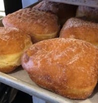 A tray of pastries on a shelf
Description automatically generated A tray of pastries on a shelf
Description automatically generated