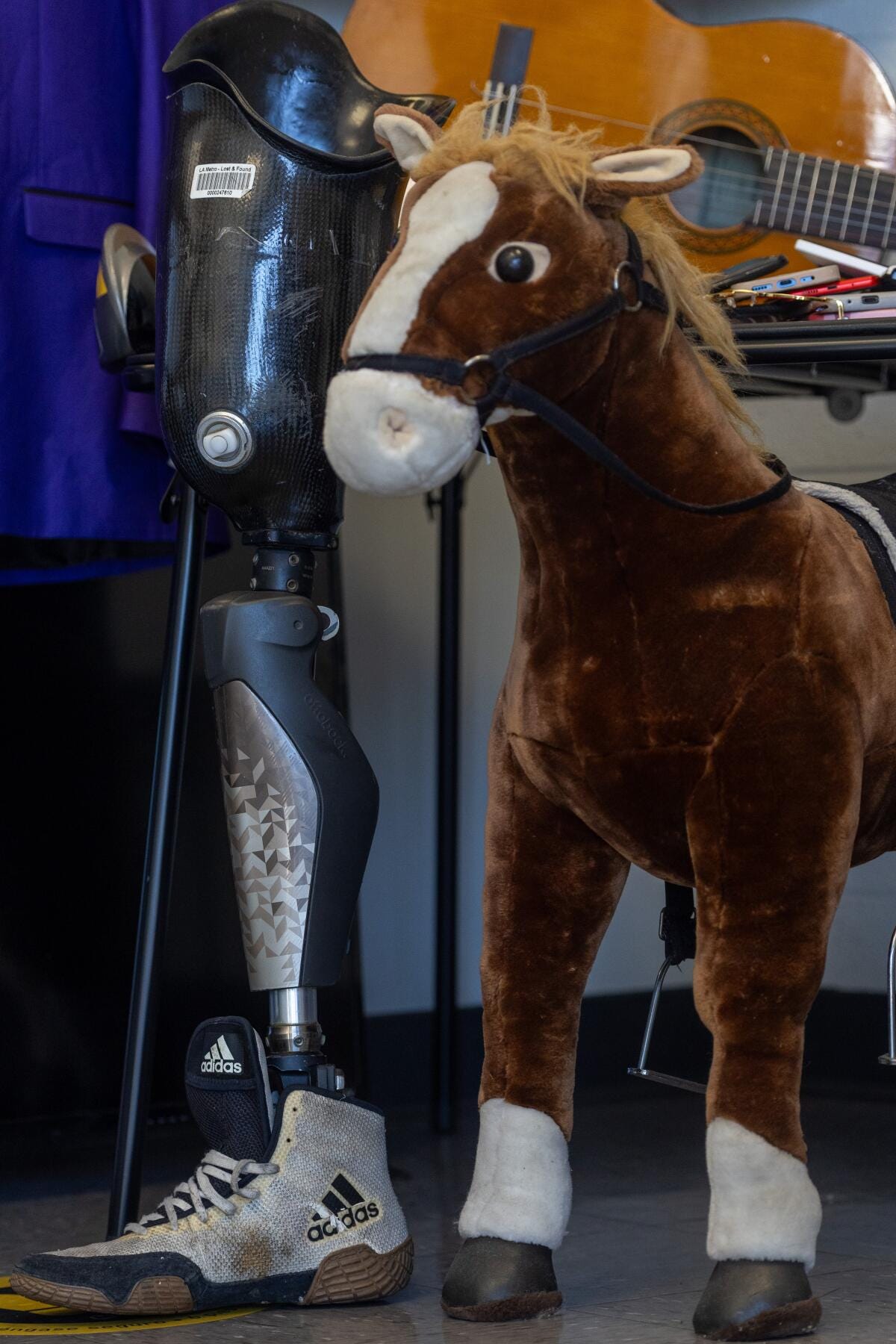 A  prosthetic leg leans alongside a toy horse 