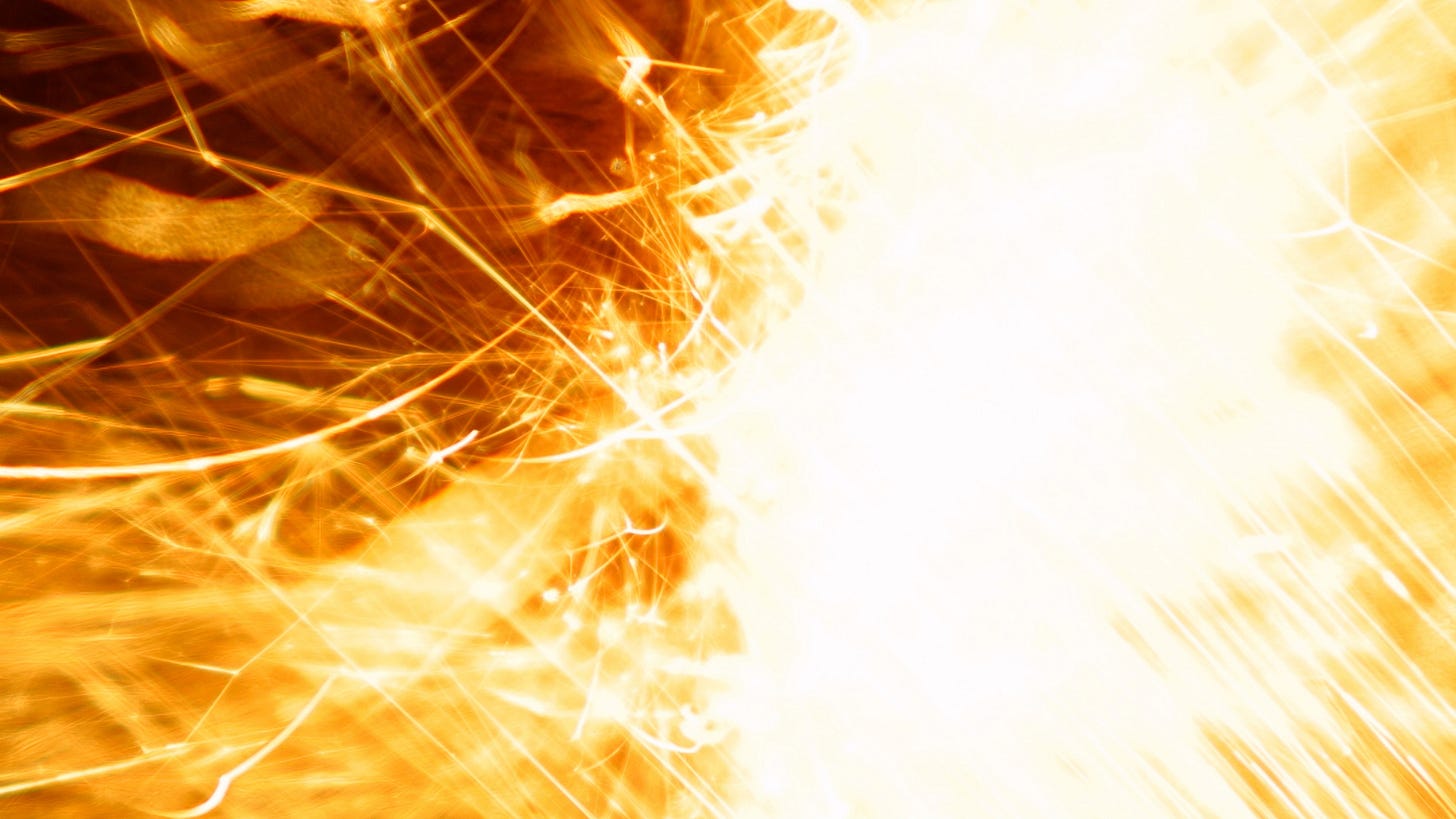 Close up of bright sparks of a sparkler fill the image