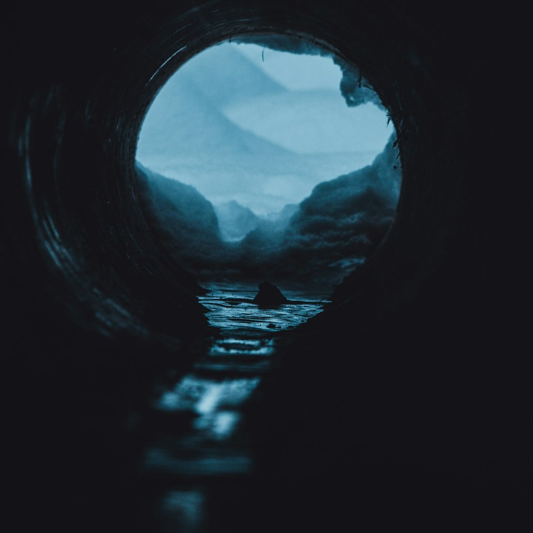 a view of a body of water through a pipe