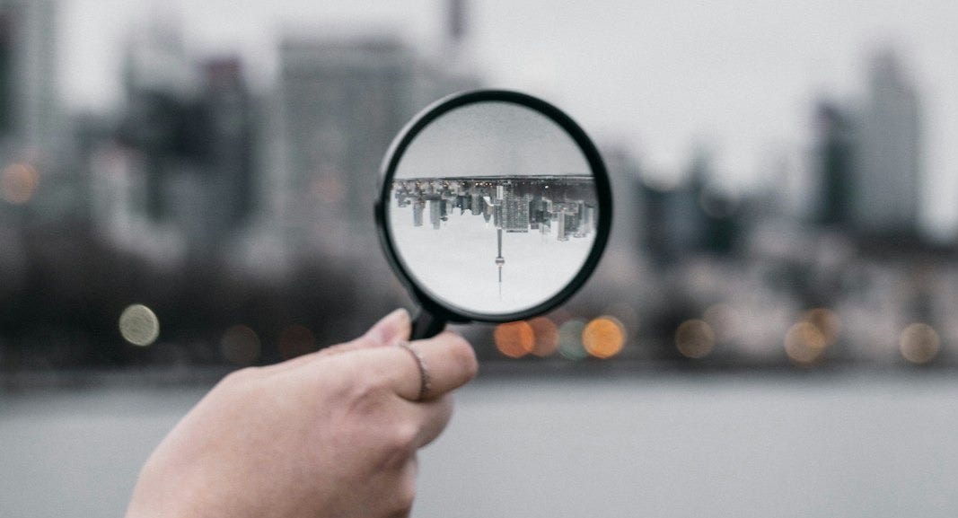 person holding magnifying glass during daytime person holding magnifying glass during daytime