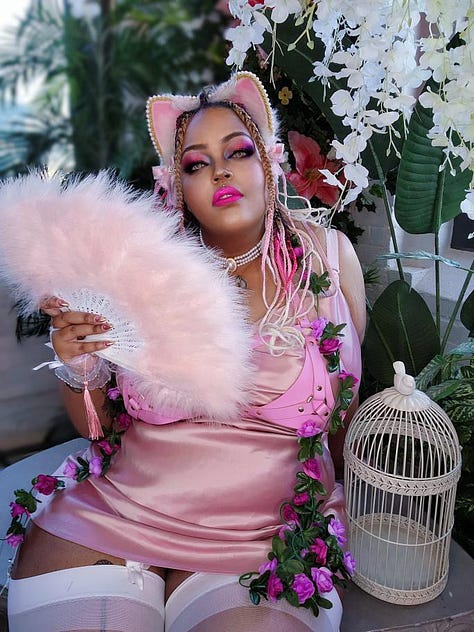 Picture 1: Bunbun wears longs braids, white bikini top and a white loin cloth. Picture 2: Bunbun wears braids with pink and white tips, a black corset, and two fox tails. BunBun growls with her claws out toward the camera. Picture 3: Bunbun sits majestically in pink lingerie, and a pink feathered fan. Pink and white ears sit atop her head.
