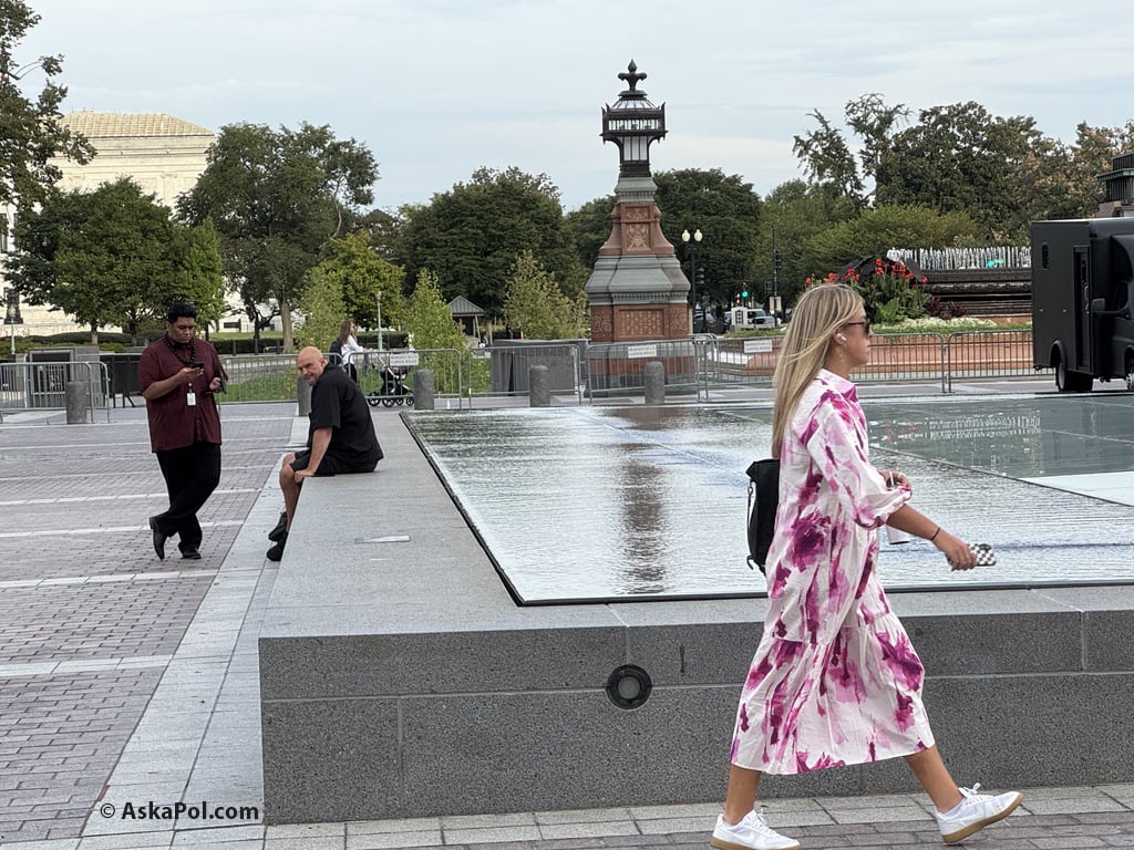 A lady in a dress walks past water. Photo: Matt Laslo © www.AskaPol.com A lady in a dress walks past water. Photo: Matt Laslo © www.AskaPol.com