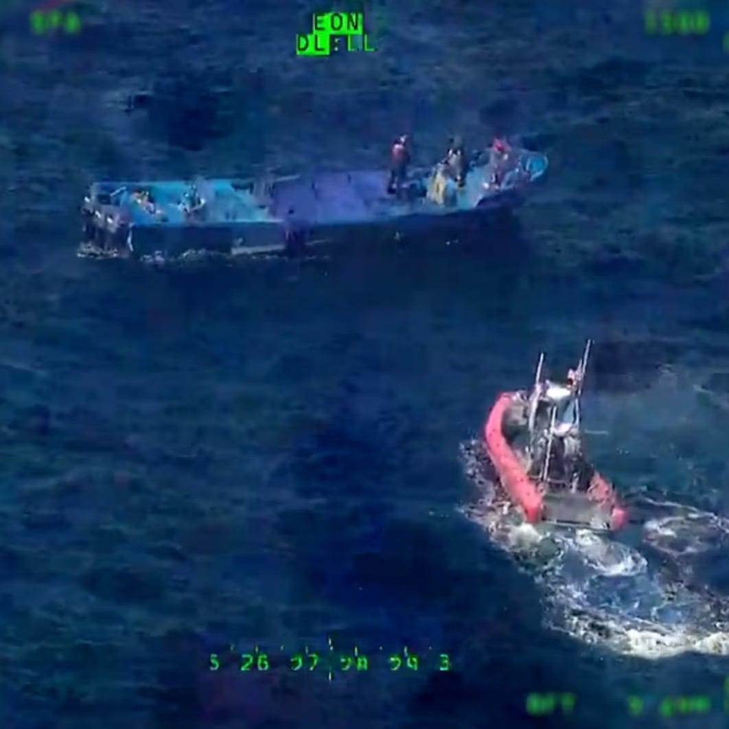 A small boat containing a law enforcement boarding party launched from the US Coast Guard Cutter Tahoma approaches cocaine smugglers.