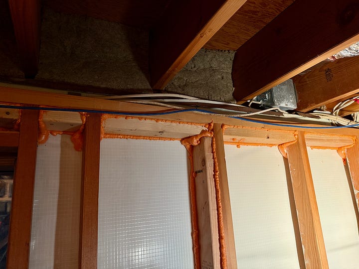 Photo mosaic of fire blocking and insulation being installed in basement walls.
