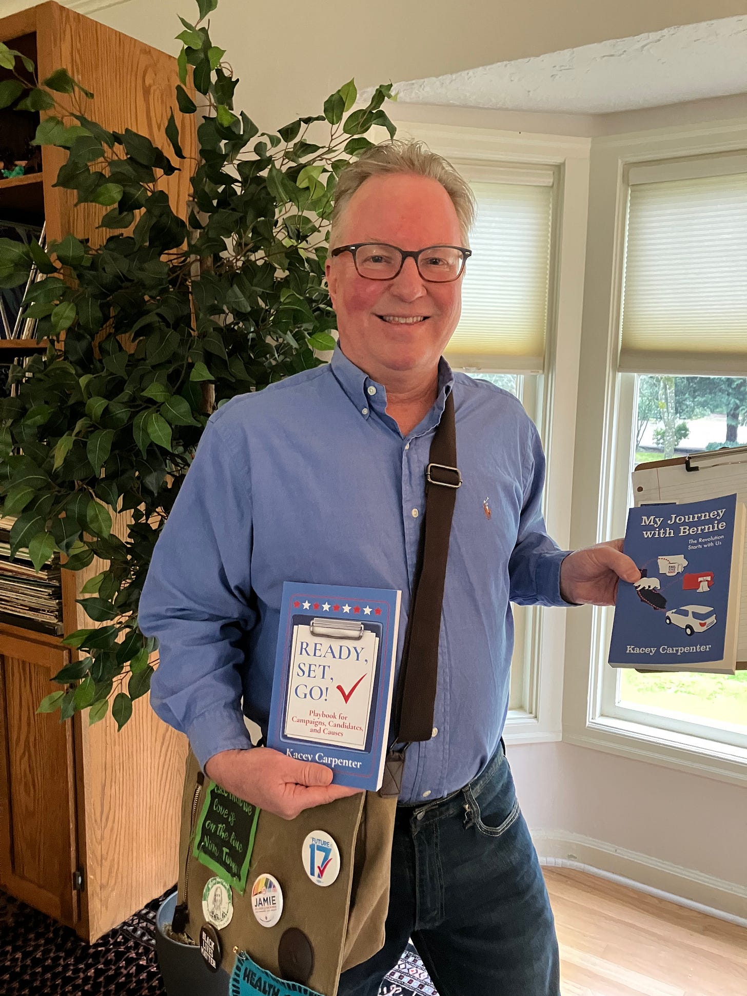 Photo of Author Kacey Carpenter holding books READY, SET, GO! Playbook for Campaigns, Candidates, and Causes and My Journey with Bernie